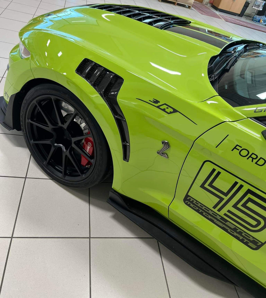 Top angle view emphasizing carbon fiber twill pattern and vent shape