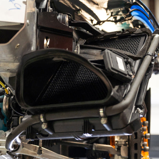 CSF heat exchanger installed in McLaren engine bay showing cooling system fitment