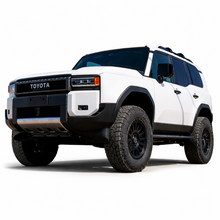 Load image into Gallery viewer, White Toyota Land Cruiser 250 Series in front three-quarter view equipped for ICON suspension upgrade