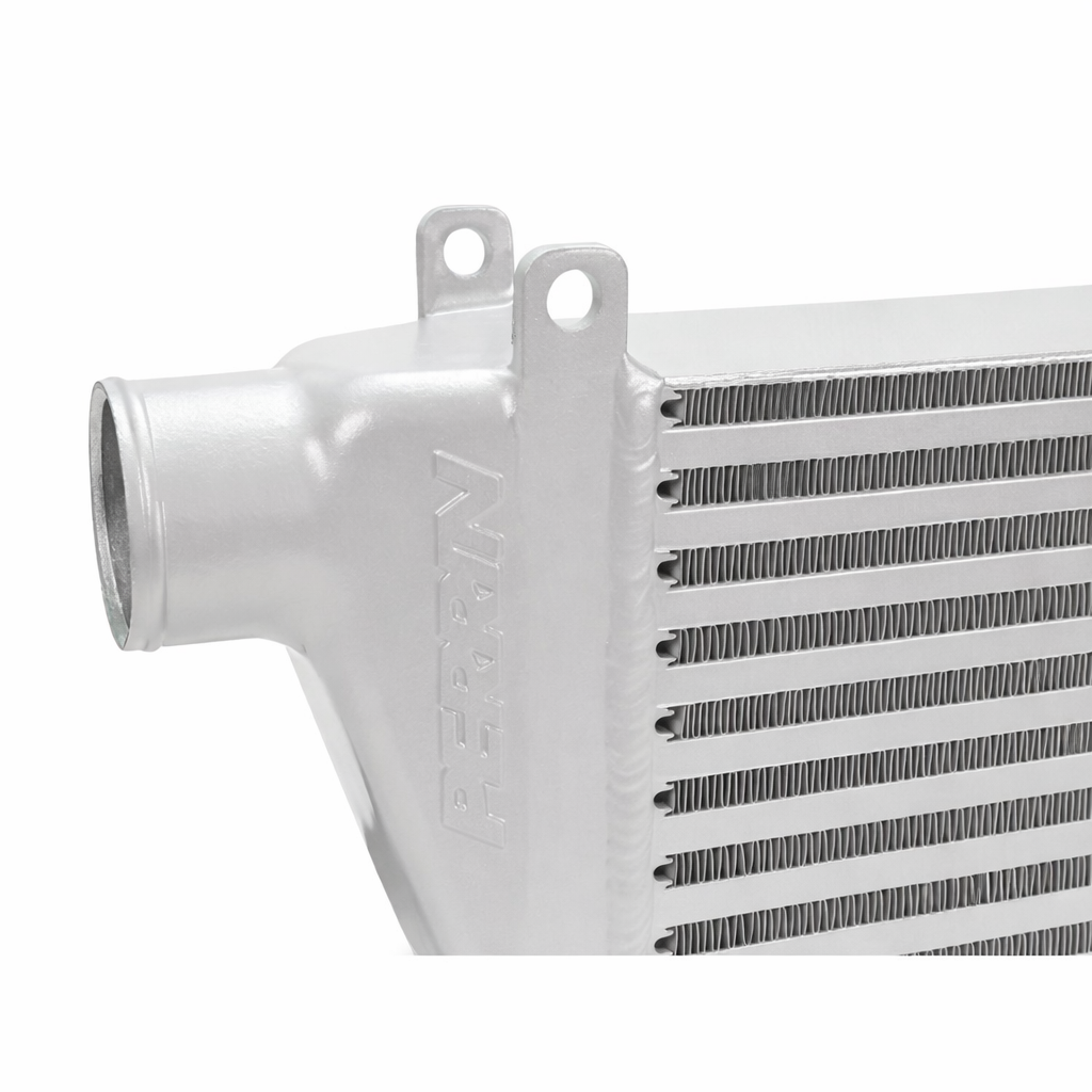 Close-up of the PERRIN intercooler end tank, inlet opening, and cooling fins on a white background.