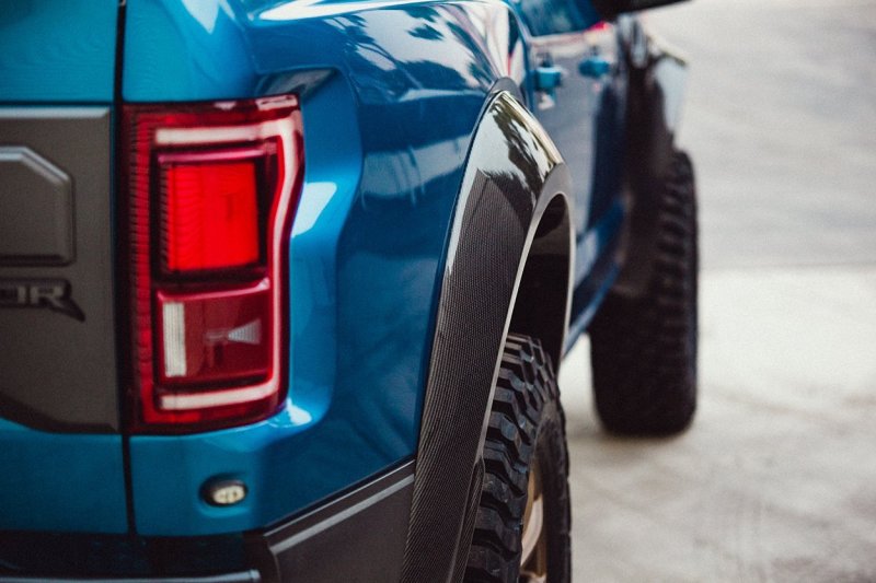 Installed view of both rear fender flares on a Ford Raptor, showcasing aggressive stance