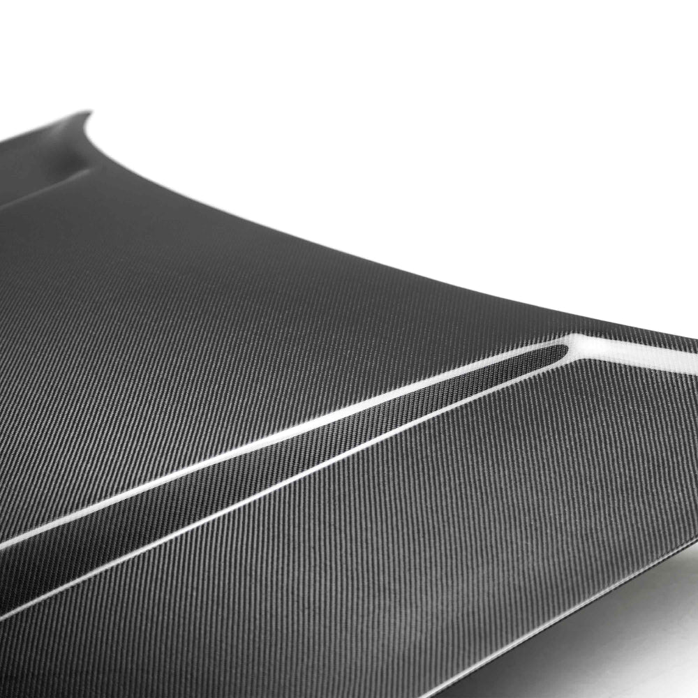 Side view of Anderson Composites Type DM Carbon Hood illustrating aerodynamic design lines.