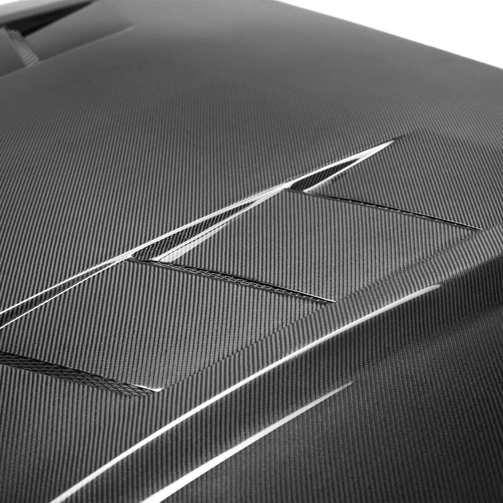Top view showing heat extractor vents and carbon fiber weave on Type-SA Mustang hood.
