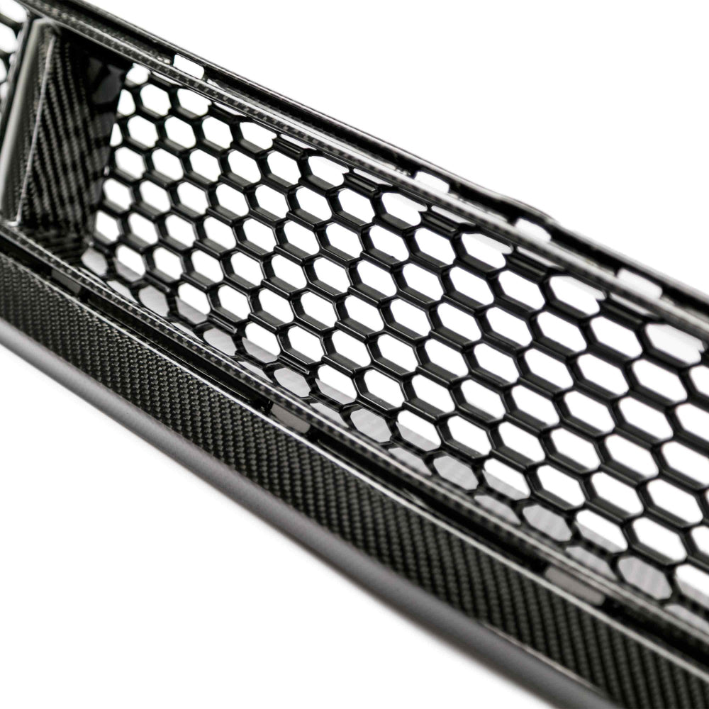 Rear mounting view showing OE-style fitment tabs on the carbon fiber lower grille