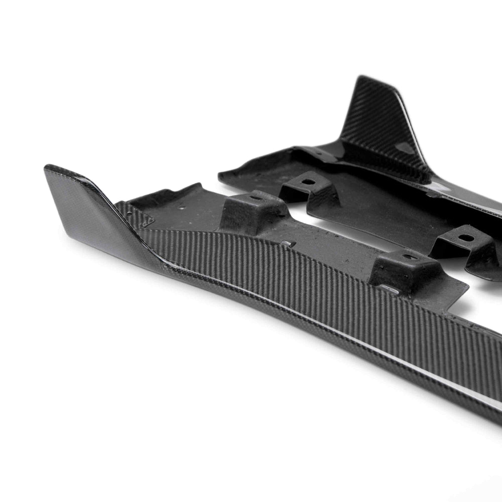 Pair of carbon fiber rocker panel splitters for 2015–2020 Shelby GT350 laid flat to show contour and edge detailing.
