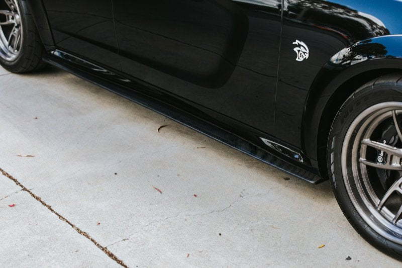 Angle view emphasizing widebody contour and carbon fiber craftsmanship.