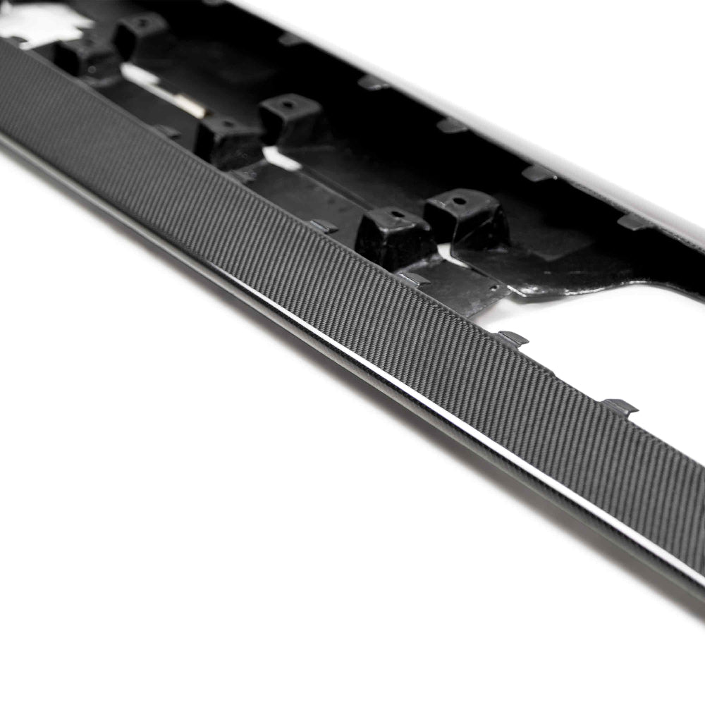 Close-up highlighting carbon fiber texture, OEM mounting points, and precise fitment.