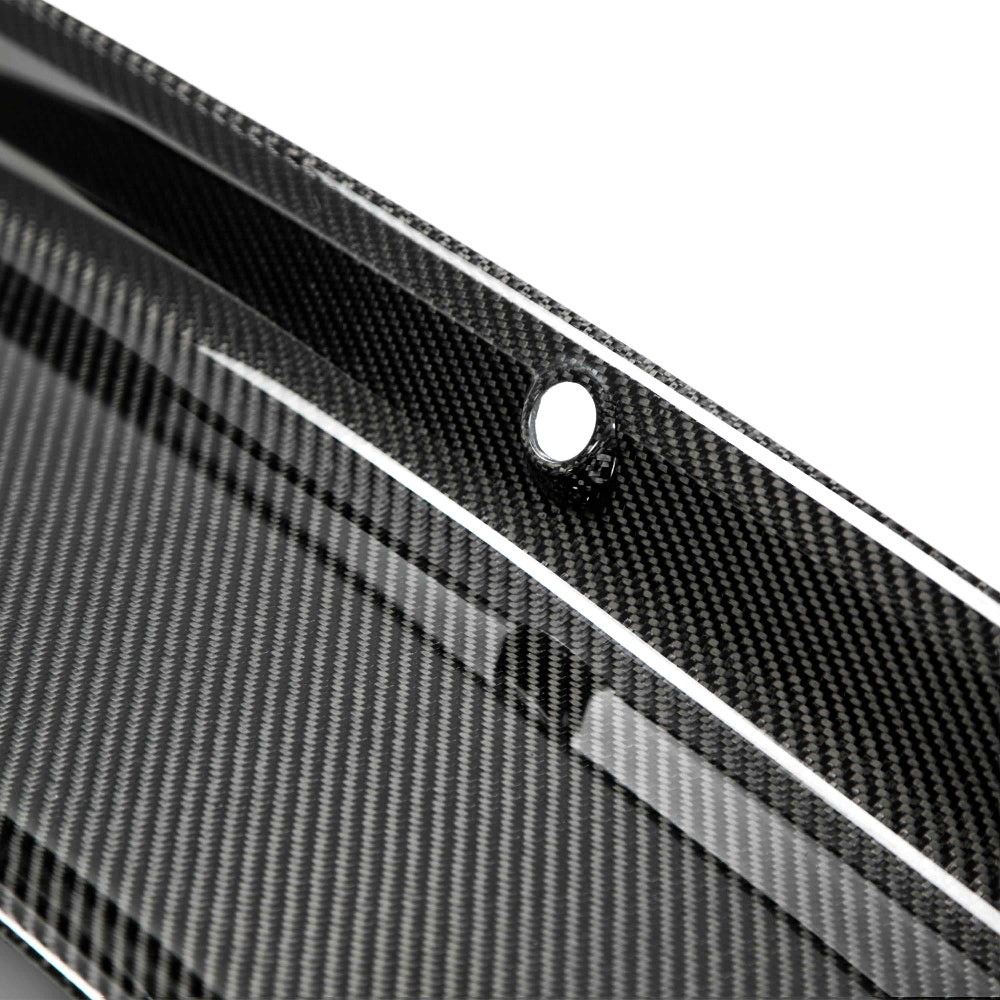 Close-up of carbon fiber weave pattern and polished UV-protected finish on decklid panel.