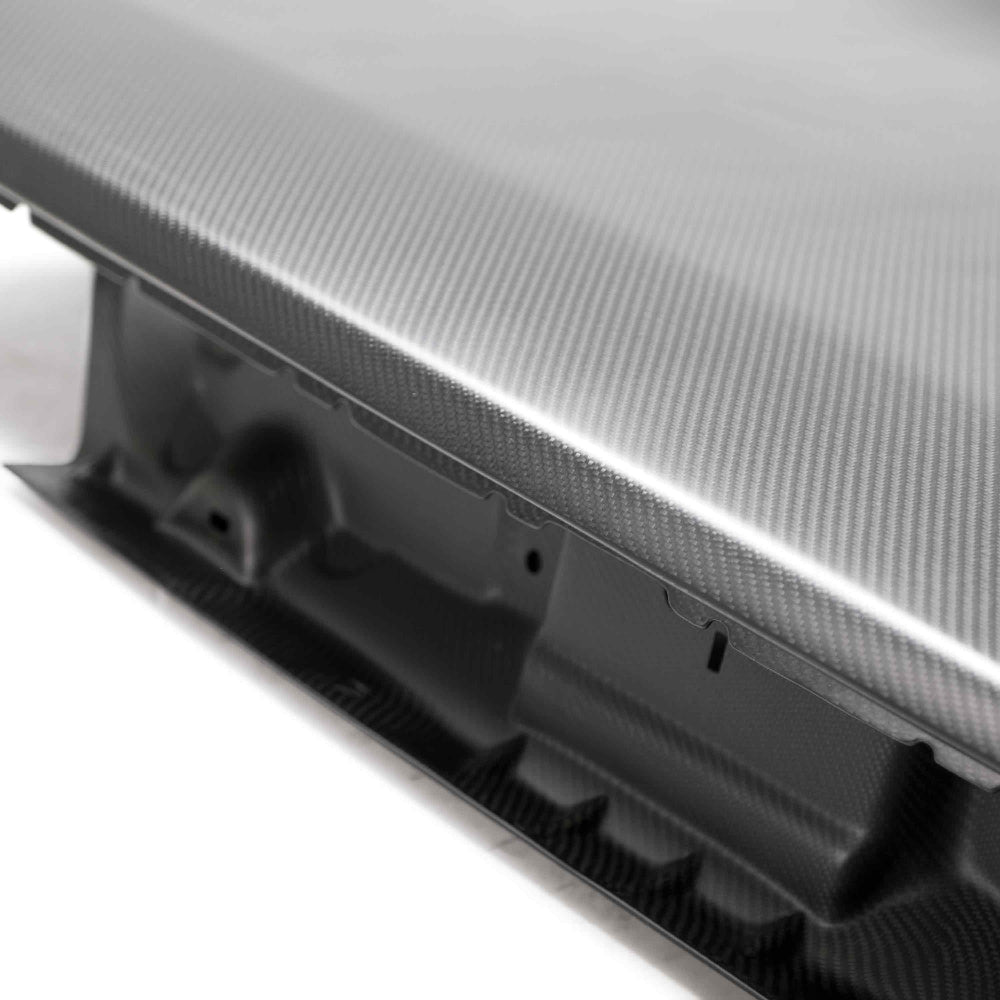 Close-up of dry carbon weave and autoclave-cured craftsmanship on the Anderson Composites decklid.