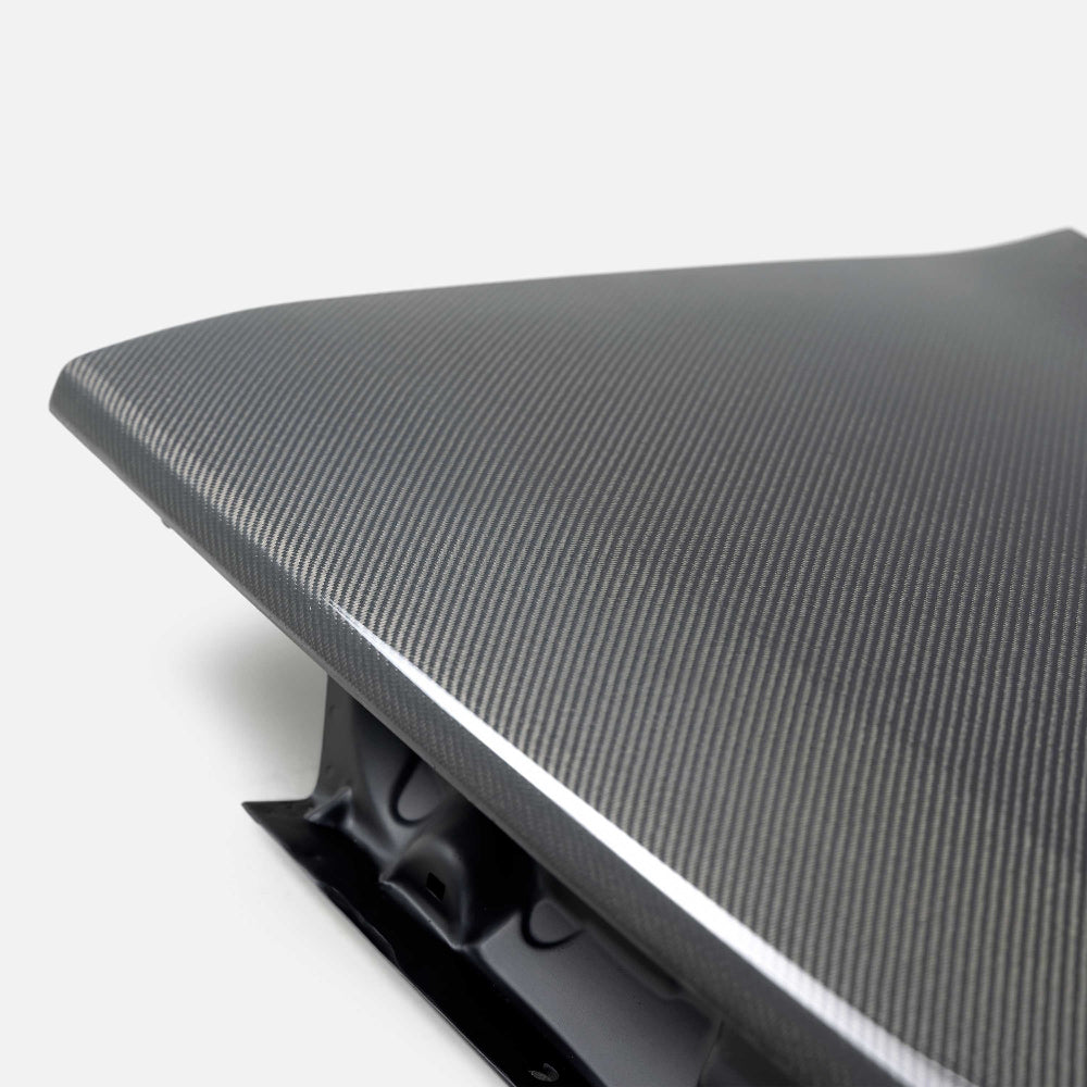 Close-up showcasing weave pattern and UV-protected clear coat of the carbon decklid.