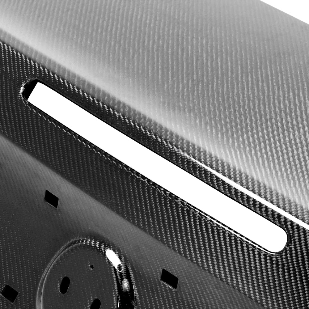 Close-up of carbon fiber texture and gloss finish detailing on the decklid.