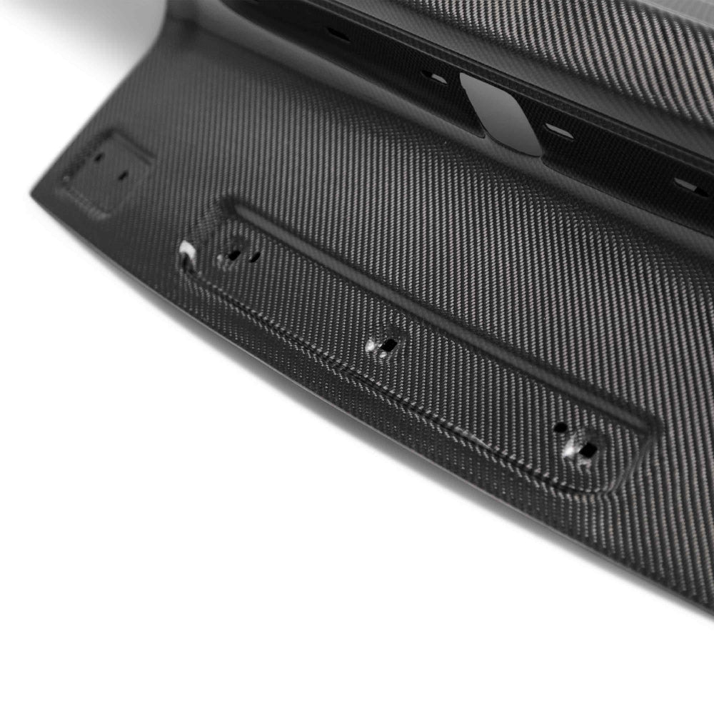 Installed view on Ford Mustang coupe illustrating the sleek carbon fiber trunk design and OEM fitment.