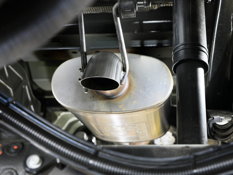 aFe Rock Basher exhaust muffler installed underneath a truck, close-up of tailpipe tip