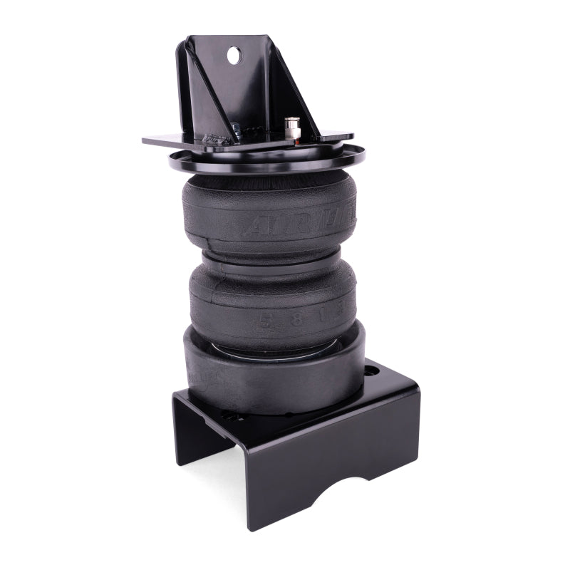 Single LoadLifter 5000 Ultimate air spring assembled to its upper bracket and steel cradle, three quarter view