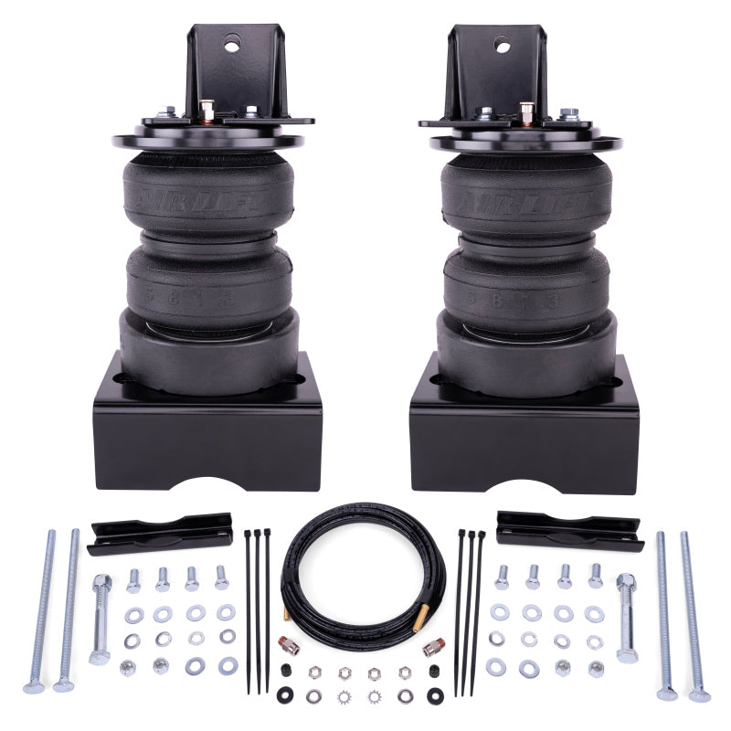 Air Lift LoadLifter 5000 Ultimate kit laid out with two air springs on brackets, air line, bolts, washers and spacers