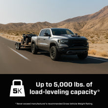 Load image into Gallery viewer, Grey Ram TRX towing a trailer on a desert highway with a graphic stating up to 5,000 pounds of load levelling capacity