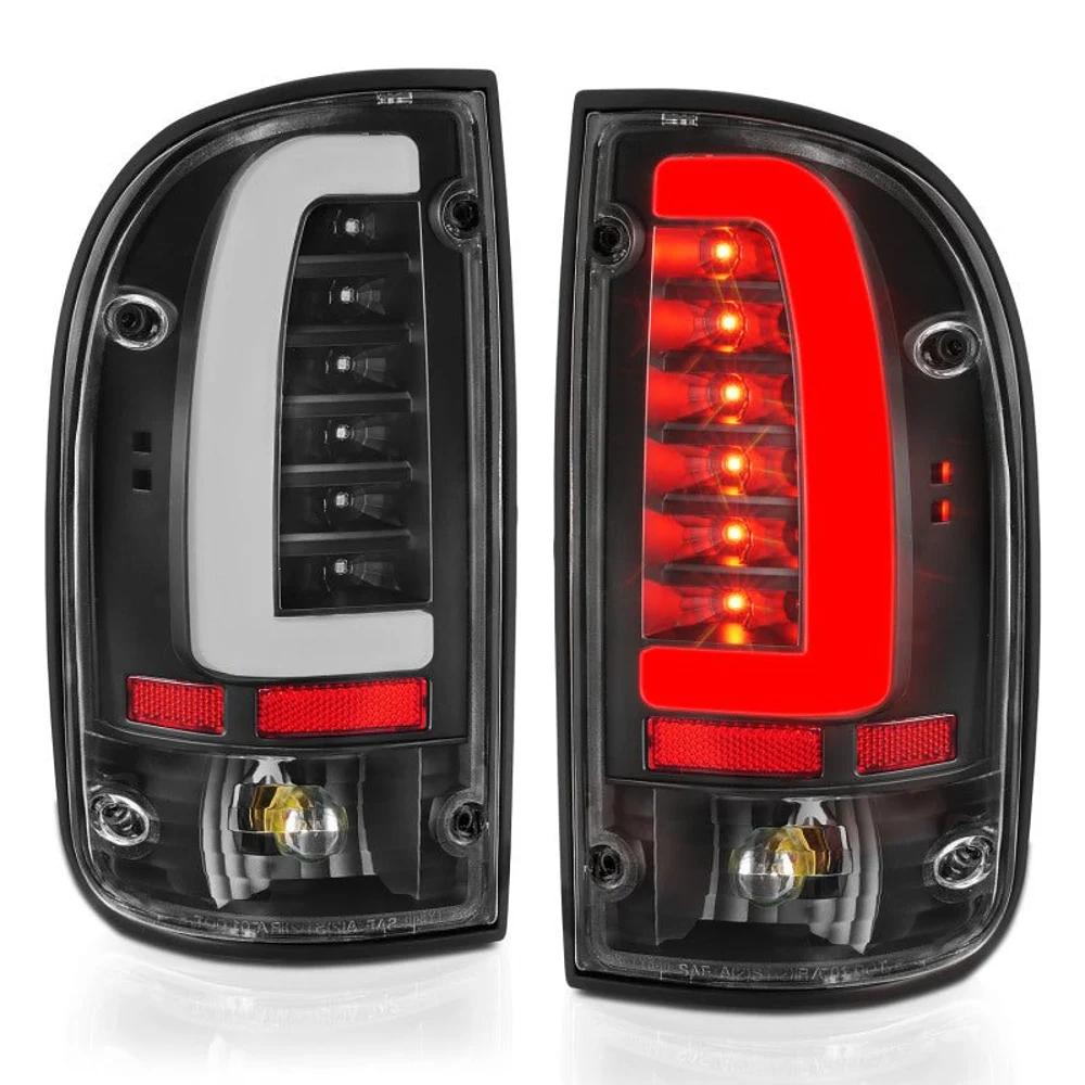 ANZO 311353 LED tail lights for 1995-2000 Toyota Tacoma, black housing clear lens pair angled with white and red LED bars illuminated