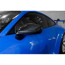 Load image into Gallery viewer, APR Performance carbon fiber mirror cover installed on blue Porsche 911 992 side view