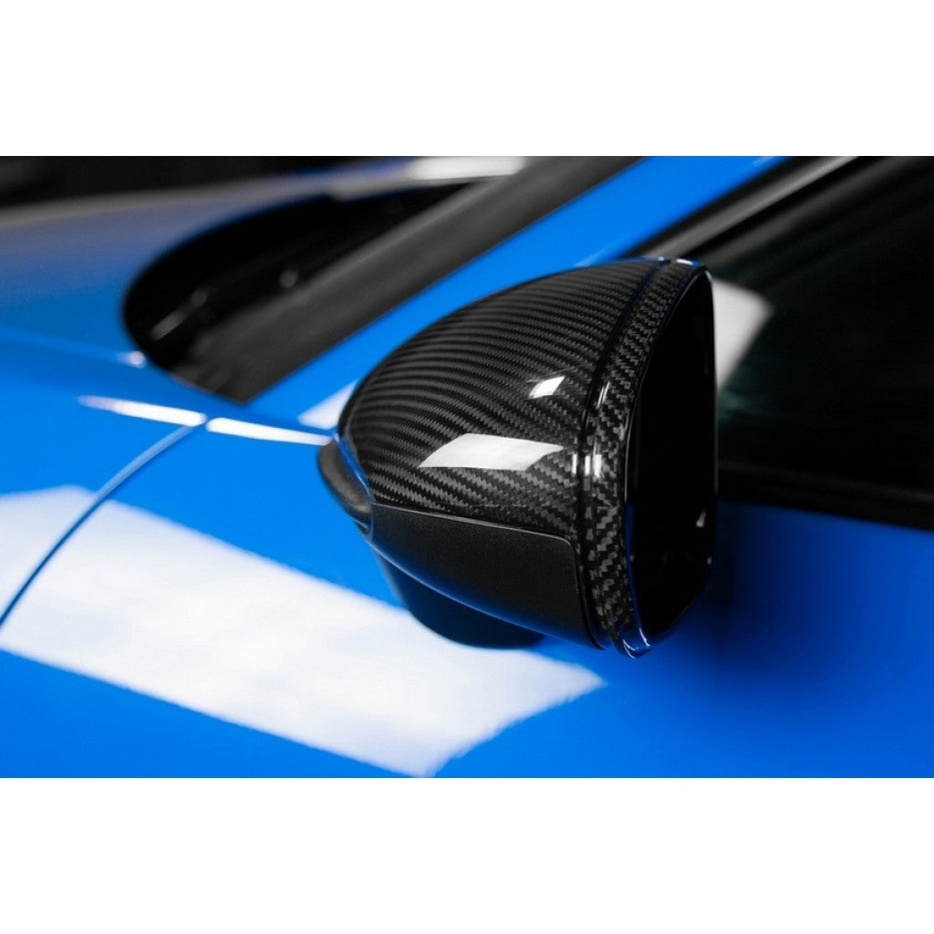 APR Performance carbon fiber mirror cover on Porsche 911 992 rear three-quarter angle