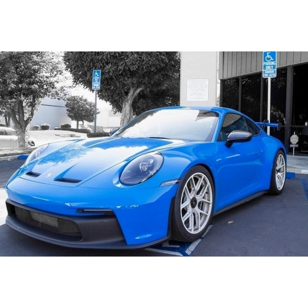 Blue Porsche 911 992 GT3 equipped with APR Performance carbon fiber mirror covers, full vehicle front view