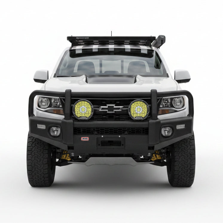 Representative installed front view of an ARB Summit winch bumper on a Chevrolet Colorado ZR2, shown with auxiliary driving lights and a roof rack that are not included