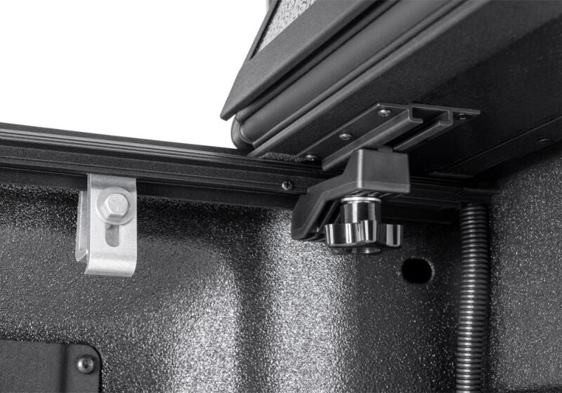 Close-up of the BAKFlip G2 corner latch and gas-strut mounting bracket