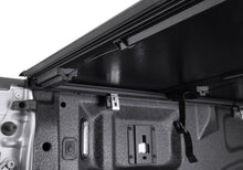 Load image into Gallery viewer, Close-up of the BAKFlip G2 tailgate-side rail and cable strap on a Ranger