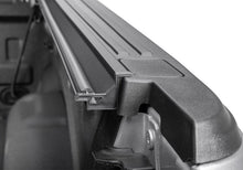 Load image into Gallery viewer, Close-up of the BAKFlip G2 folded panel stack and side rail clamp at the cab end