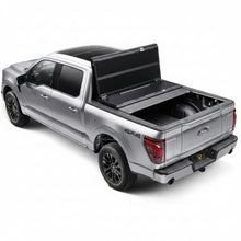 Load image into Gallery viewer, BAKFlip G2 tonneau cover with rear panel folded open on a silver Ford F-150
