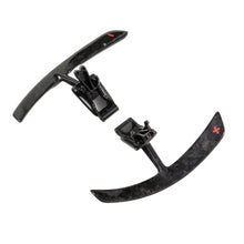 Load image into Gallery viewer, Porsche 991 carbon paddle shifter extensions with the badge on one paddle and the bracket visible on the other
