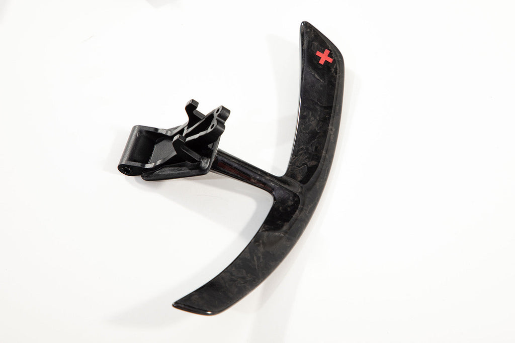 Single Porsche 991 forged carbon paddle shifter extension with its bracket and the red star badge