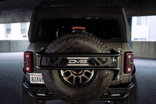 Load image into Gallery viewer, DV8 Offroad 21-23 Ford Bronco Spare Tire Guard &amp; Accessory Mount - Black Ops Auto Works