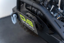 Load image into Gallery viewer, DV8 Offroad Fairlead Mounted Flip-Up License Plate Bracket DV8 Offroad DVELPBM-02