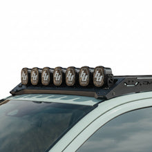 Load image into Gallery viewer, Angled shot of the mount attached to a DV8 Spec Series Roof Rack with the light option.