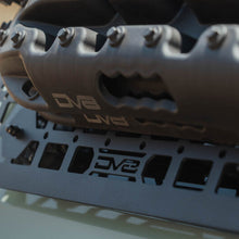Load image into Gallery viewer, Close-up of the molle panel's 1.5-inch by 1-inch cutout grid pattern.