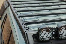 Load image into Gallery viewer, Close-up of DV8 roof rack rail with DV8 branded end caps