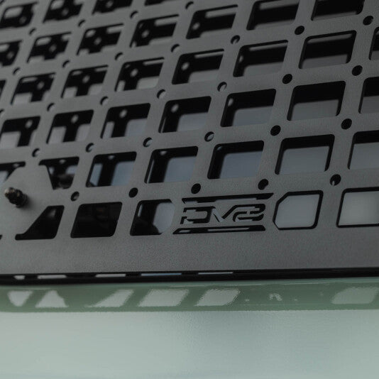 Close-up of the black powder-coated Molle grid openings