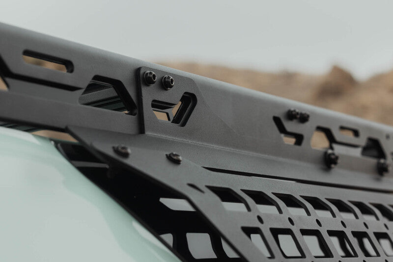 Close-up of the DV8 branding and mounting edge on the window Molle panel