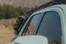 Load image into Gallery viewer, DV8 window molle panel installed on 4Runner, driver side rear window close-up