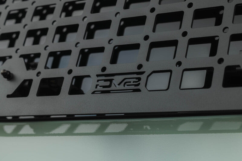Close-up of DV8 molle panel weave with embossed DV8 logo, top-down view