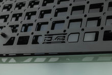 Load image into Gallery viewer, Close-up of DV8 molle panel weave with embossed DV8 logo, top-down view