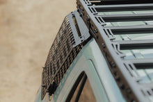Load image into Gallery viewer, Close-up of DV8 molle panel mounted at roof rack corner joint