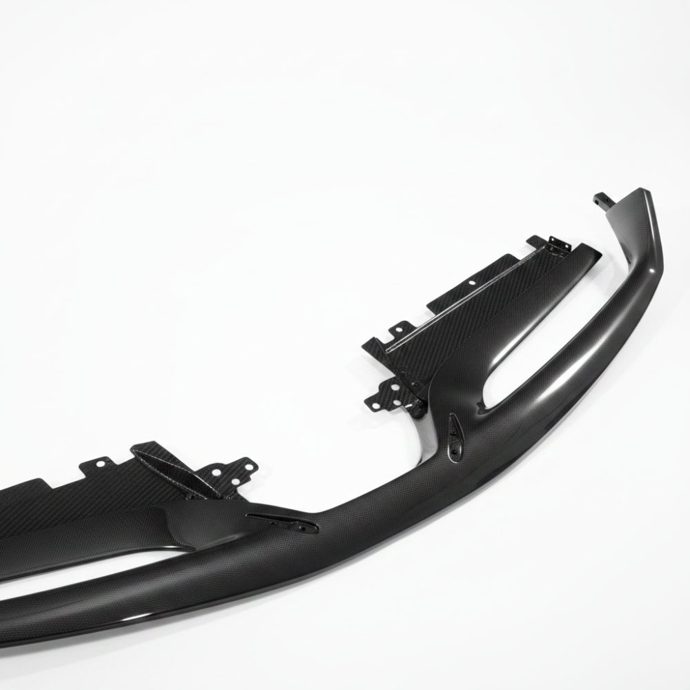 Ferrari 488 carbon fiber front lip in three quarter view from the right with the mounting tabs visible