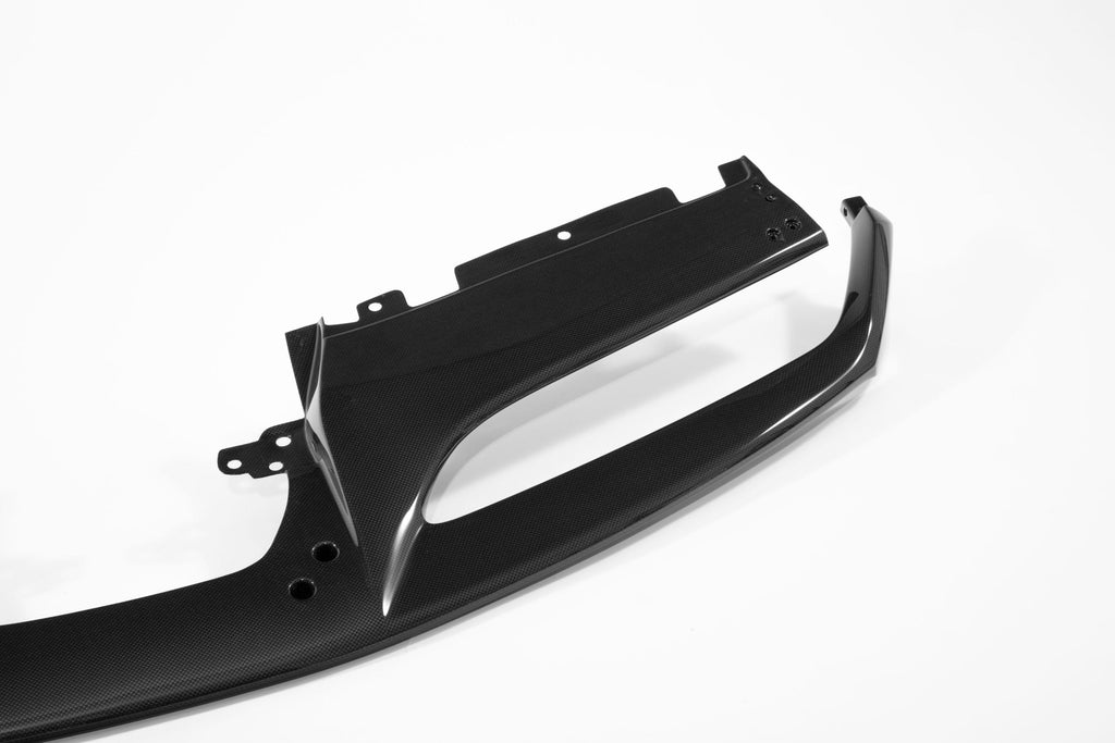 Underside of the Ferrari 488 carbon fiber front lip showing the reinforced mounting tabs and fixing holes