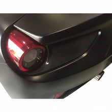 Load image into Gallery viewer, Carbon fiber tail light surround installed around the round red rear light of a matte finished Ferrari 488