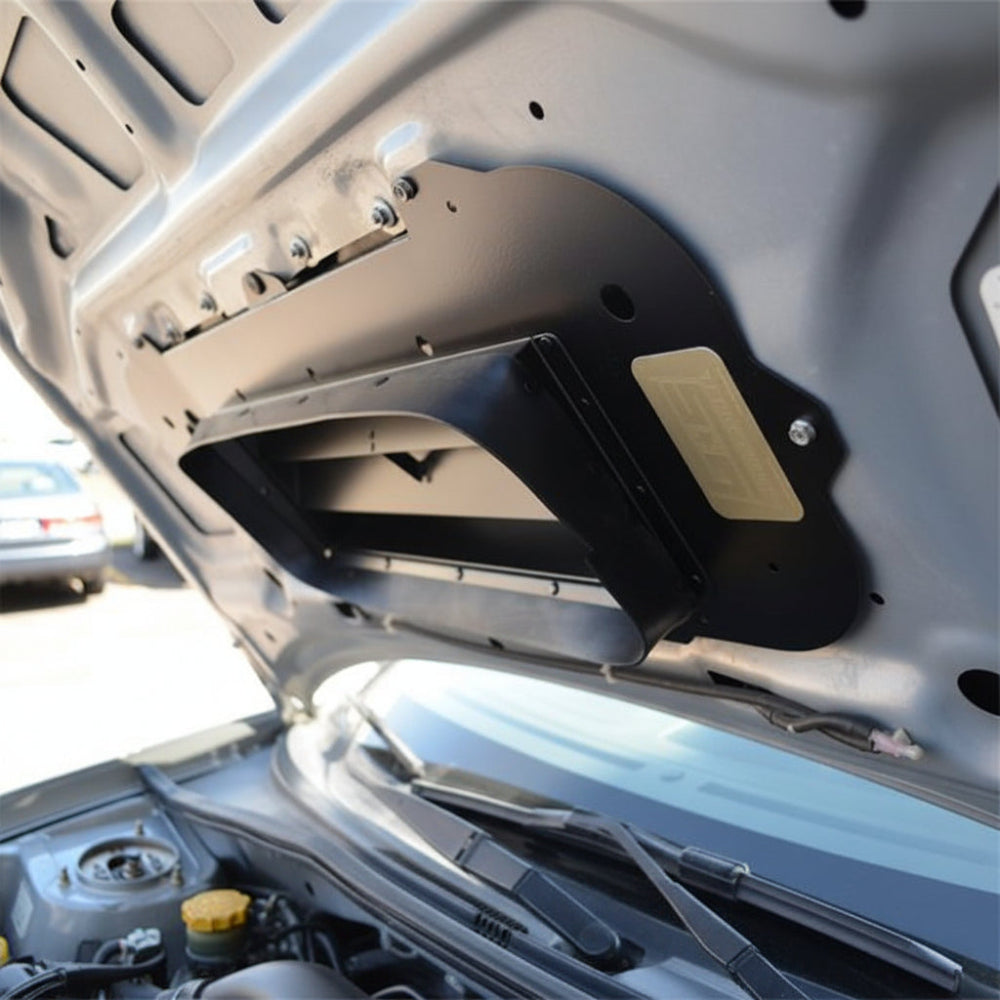 GrimmSpeed 093077 TMIC splitter installed beneath a Subaru hood