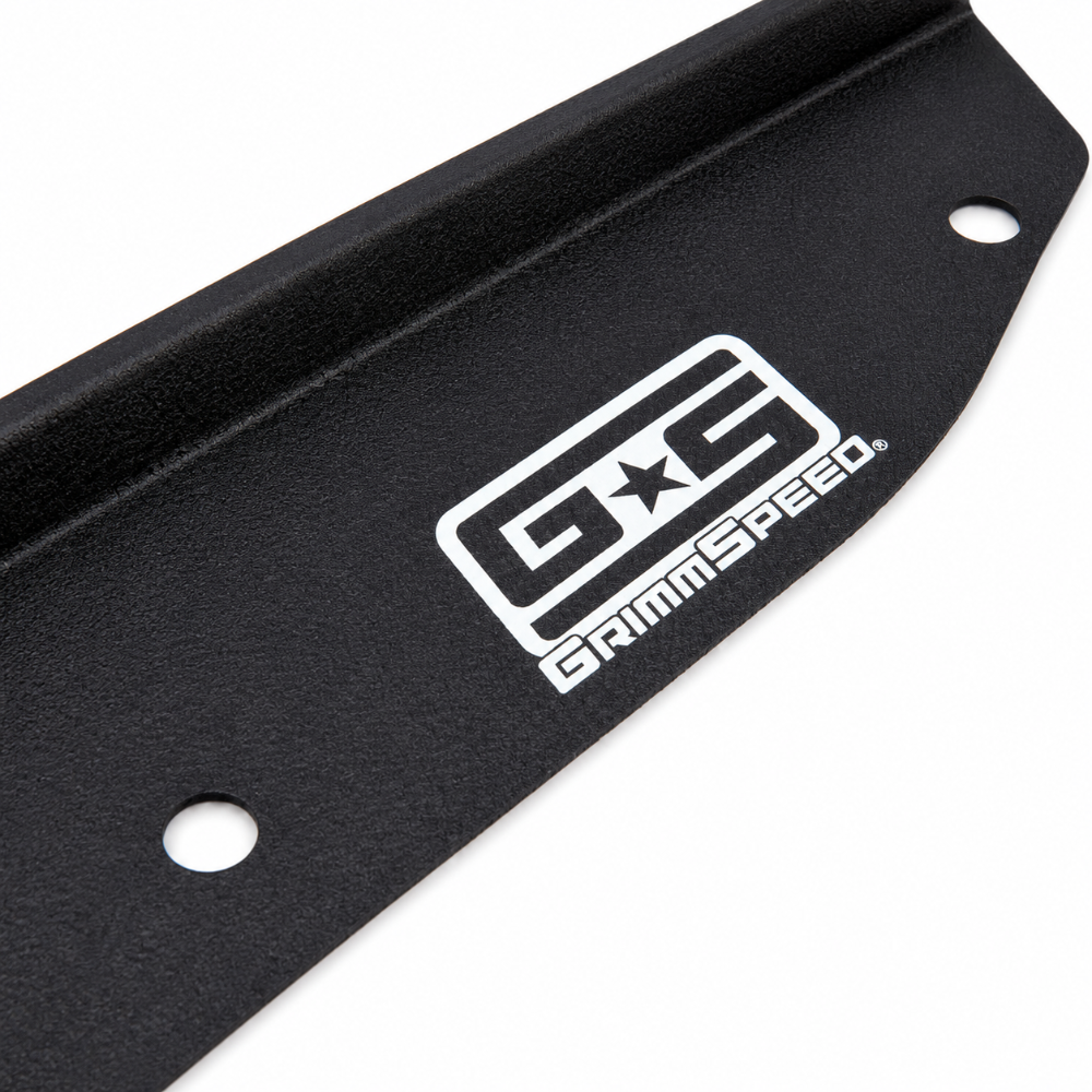 Close-up of the GrimmSpeed logo on the black aluminum radiator shroud