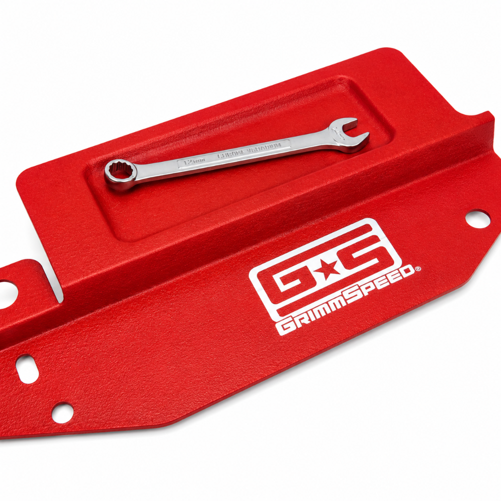Close-up of the GrimmSpeed logo on the red aluminum radiator shroud