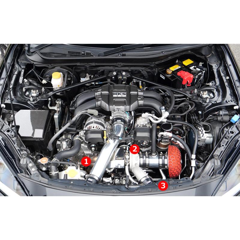 HKS bolt-on turbo kit components installed in an engine bay, numbered callouts