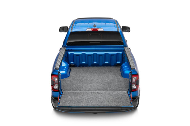 Husky Liners bed liner installed in a blue truck bed, viewed from directly above the bed